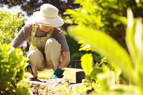 Professional landscaper mowing a lush green lawn.